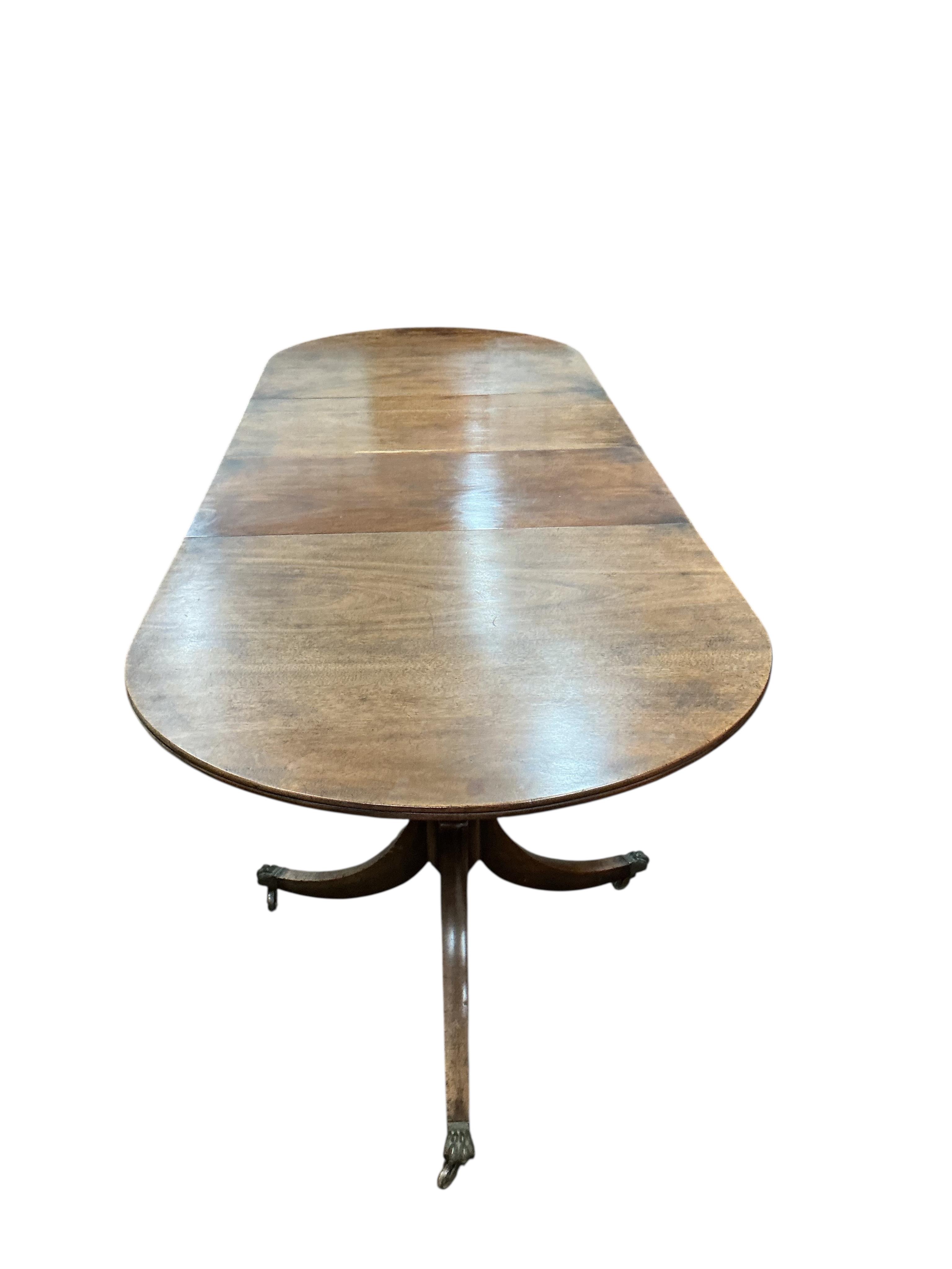 A George III style mahogany twin pillar 'D' end extending dining table, width 260cm extended, two spare leaves, depth 91cm, height 72cm